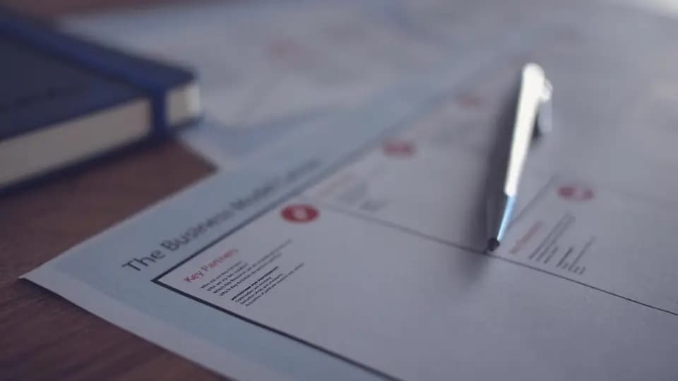 A pen resting on a printed business letter, ready to sign a resignation