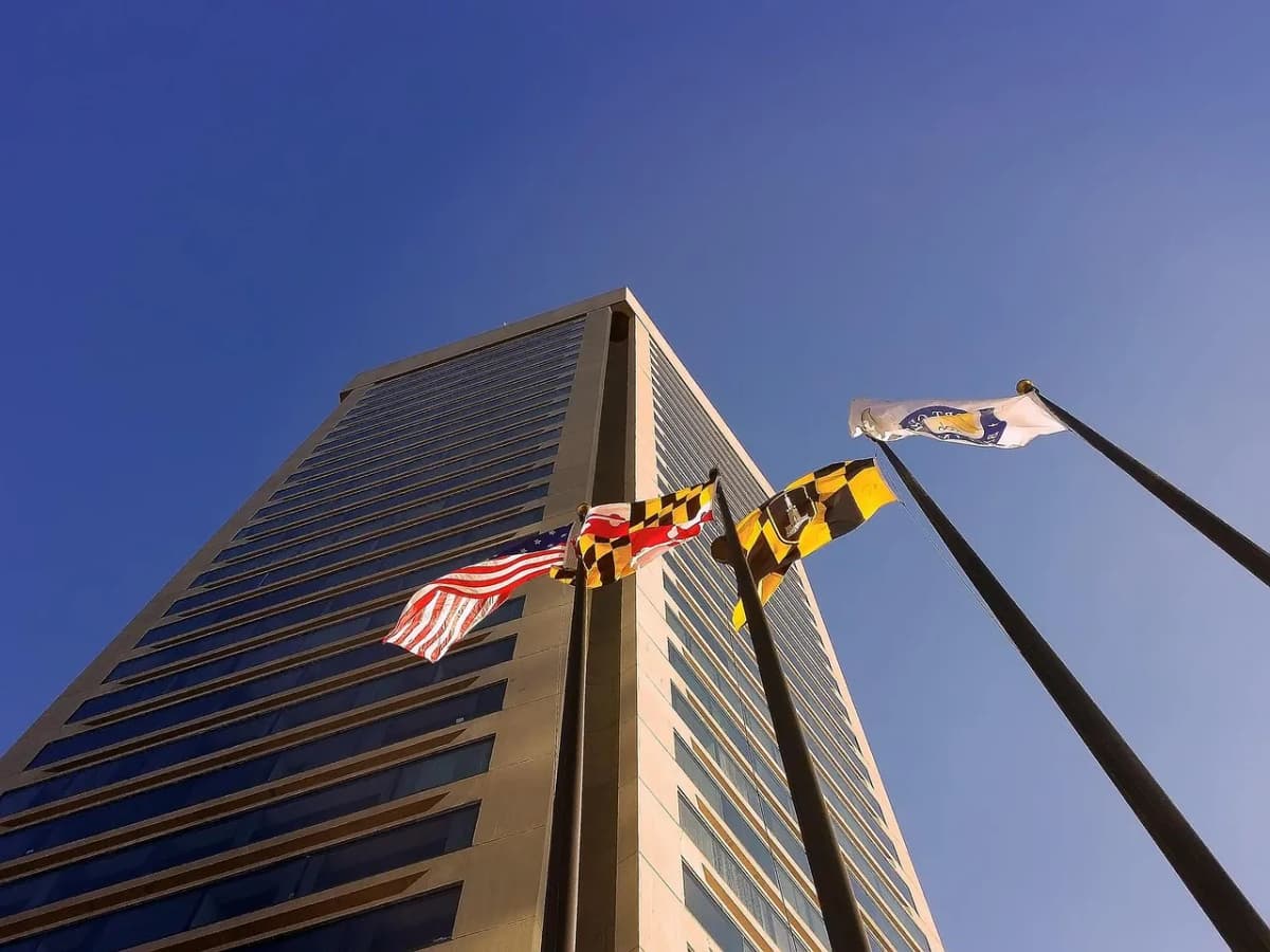 Flags flying outside office towers in a US city, as September hiring came in close to flat