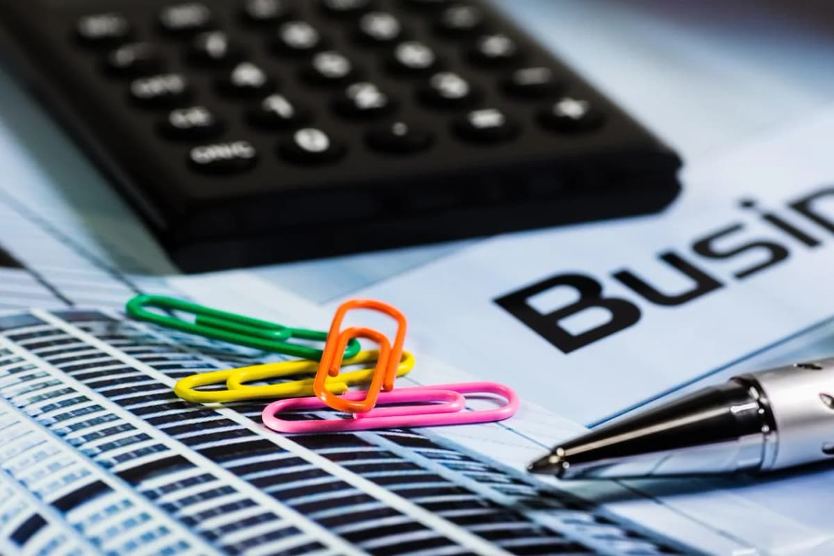 A calculator and papers on a desk, as BLS reports median weekly pay of $1,232