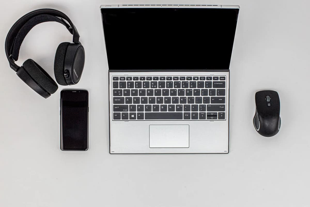 Laptop and headset on a home desk set up for remote customer service work