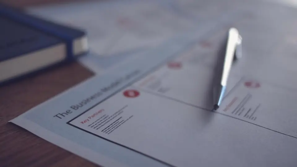 A pen resting on a printed business letter, ready to sign a resignation