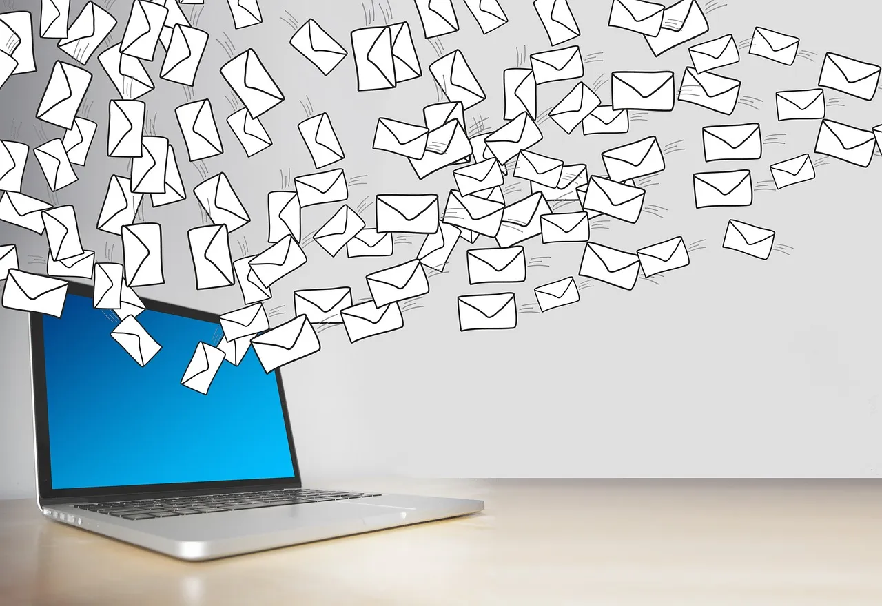 Illustration of envelopes flying out of a laptop screen, like a flood of emails