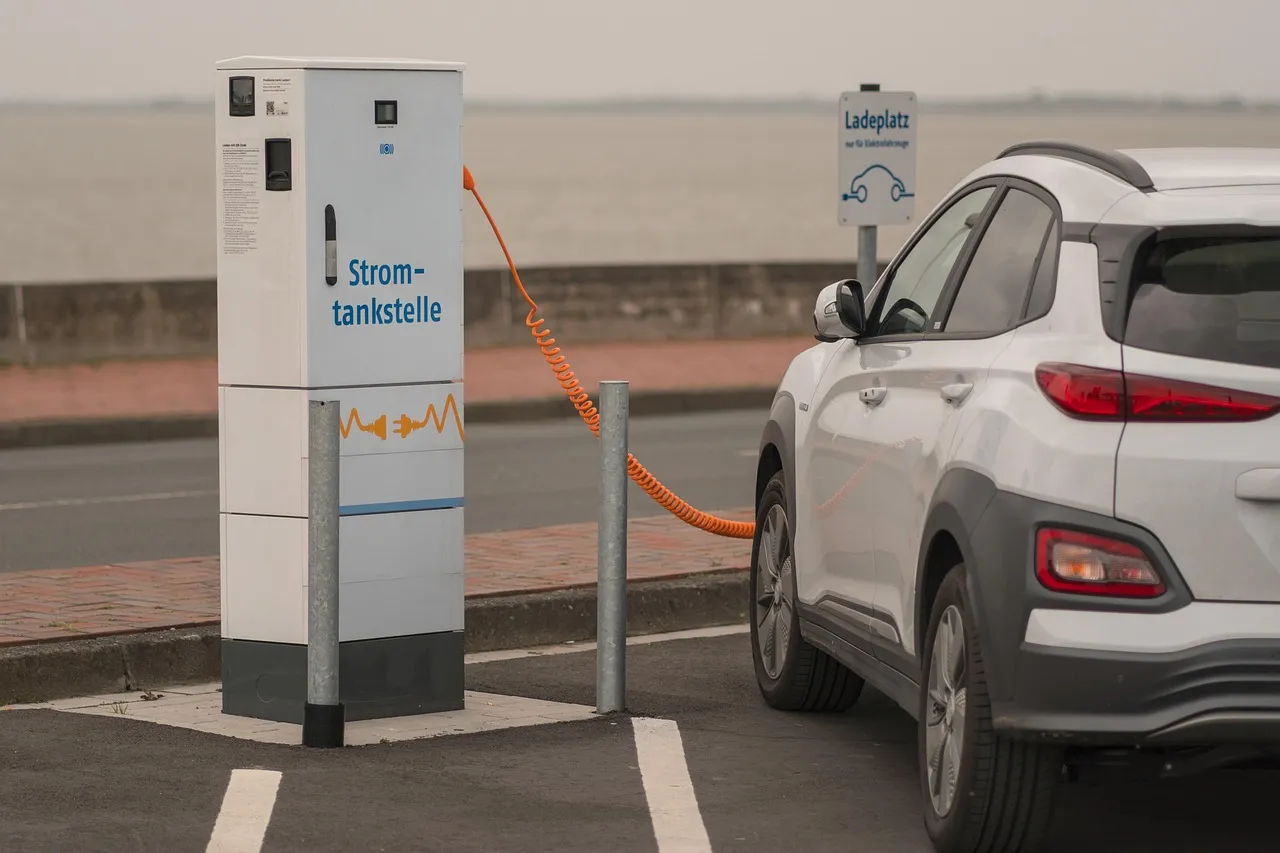 White SUV parked beside a public electric vehicle charging station