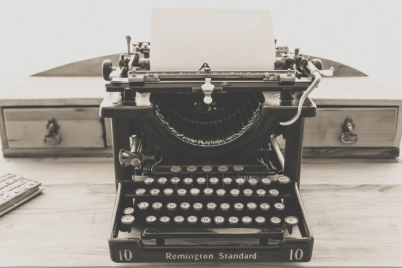 Vintage typewriter with a blank sheet of paper loaded