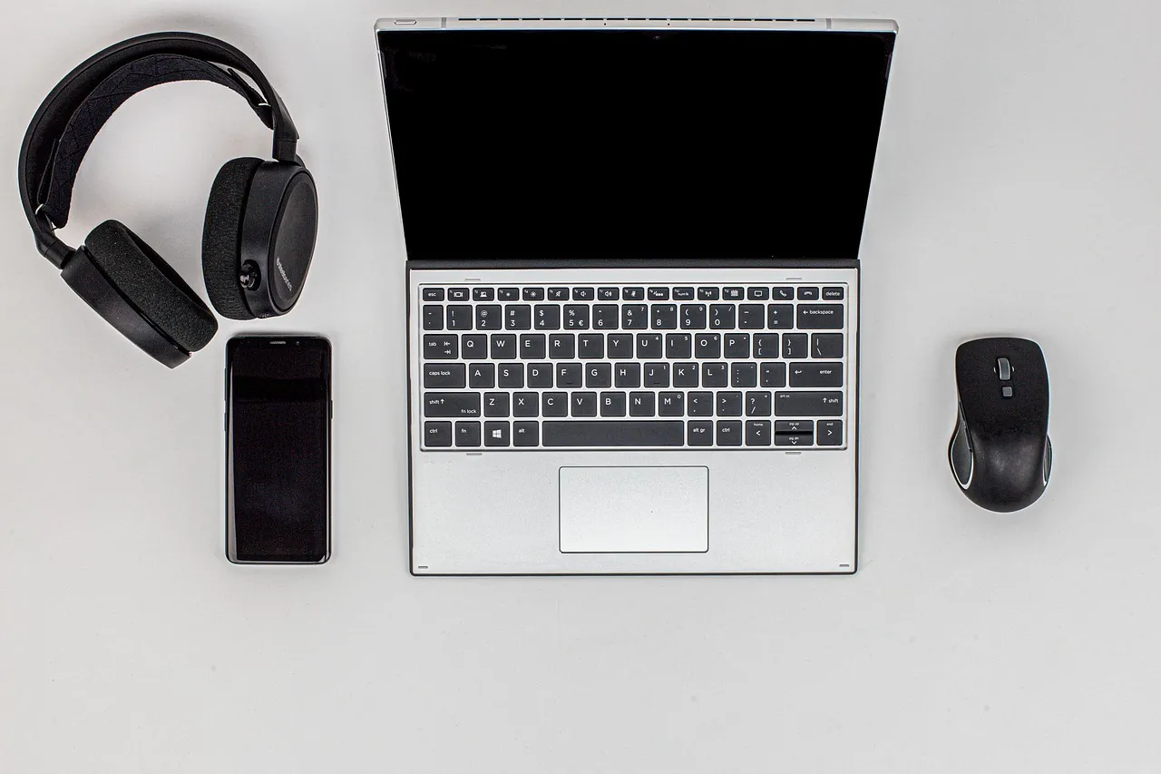 Laptop and headset on a home desk set up for remote customer service work